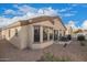 Low-maintenance backyard with rock landscaping, covered patio, and privacy fence at 2101 S Meridian Rd # 176, Apache Junction, AZ 85120