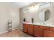 Bathroom features wood cabinets, double sinks, and a decorative flower vase at 2101 S Meridian Rd # 176, Apache Junction, AZ 85120