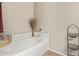 Soaking tub is surrounded by white tile and features decorative vase at 2101 S Meridian Rd # 176, Apache Junction, AZ 85120