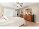 Bedroom features a double-door closet and a dresser with a wooden-framed mirror at 2101 S Meridian Rd # 176, Apache Junction, AZ 85120