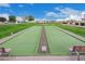 Bocce ball court surrounded by green space, offering a recreational and social outdoor amenity at 2101 S Meridian Rd # 176, Apache Junction, AZ 85120