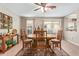 Inviting dining room with a ceiling fan, natural light, and wooden furniture set at 2101 S Meridian Rd # 176, Apache Junction, AZ 85120