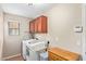 Laundry room features newer white washer and dryer and upper wood cabinets at 2101 S Meridian Rd # 176, Apache Junction, AZ 85120