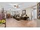 Open-concept living room with ceiling fans, tile floors, and archways to the dining area at 2101 S Meridian Rd # 176, Apache Junction, AZ 85120