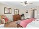 Bright main bedroom boasts a ceiling fan, warm paint, and a beautiful wooden dresser with large mirror at 2101 S Meridian Rd # 176, Apache Junction, AZ 85120