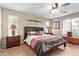 Serene main bedroom featuring a ceiling fan, warm lighting, and a comfortable king-size bed at 2101 S Meridian Rd # 176, Apache Junction, AZ 85120