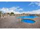 Community pool with a hot tub, lounge chairs and beautiful blue skies at 2101 S Meridian Rd # 176, Apache Junction, AZ 85120