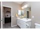 Bathroom vanity with double mirrors and a doorway view to a decorative hallway at 22465 E Via Del Verde --, Queen Creek, AZ 85142