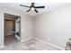 Bedroom with neutral walls, ceiling fan, and an open view to the hall and built-in storage at 22465 E Via Del Verde --, Queen Creek, AZ 85142