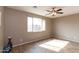 The bedroom features tile floors, a ceiling fan, and natural light from a large window at 22465 E Via Del Verde --, Queen Creek, AZ 85142