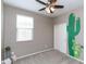 Bedroom featuring a ceiling fan, carpet, and a decorative cactus wall art at 22465 E Via Del Verde --, Queen Creek, AZ 85142