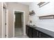 Hallway with a decorative shiplap wall, shelves, and a black storage console at 22465 E Via Del Verde --, Queen Creek, AZ 85142