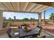 Covered back patio with table and chairs that offers views of the golf course at 22524 N San Ramon Dr, Sun City West, AZ 85375