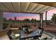 A covered patio seating area overlooks the green golf course and desert landscape at 22524 N San Ramon Dr, Sun City West, AZ 85375