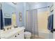 Cozy bathroom with blue walls, a shower-tub combo, and a white vanity at 22524 N San Ramon Dr, Sun City West, AZ 85375