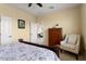 Cozy bedroom featuring neutral tones, a dresser, and a comfortable armchair at 22524 N San Ramon Dr, Sun City West, AZ 85375