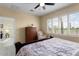 Bright bedroom with a tall dresser, providing lots of natural light and backyard views at 22524 N San Ramon Dr, Sun City West, AZ 85375