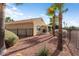 Landscaped home exterior with a covered patio and beautiful palm trees at 22524 N San Ramon Dr, Sun City West, AZ 85375