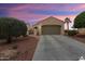 Single-story home featuring desert landscaping and a wide driveway leading to a two-car garage at 22524 N San Ramon Dr, Sun City West, AZ 85375