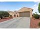 Inviting single-level house showcasing a neatly kept front yard, xeriscaping, and attached garage at 22524 N San Ramon Dr, Sun City West, AZ 85375