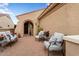 Inviting front patio with comfortable seating and a charming entrance to the home at 22524 N San Ramon Dr, Sun City West, AZ 85375