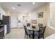 Bright kitchen with stainless steel appliances, tile backsplash, and adjacent breakfast nook at 22524 N San Ramon Dr, Sun City West, AZ 85375