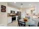 Charming kitchen with white cabinetry, stainless steel appliances, and cozy breakfast nook at 22524 N San Ramon Dr, Sun City West, AZ 85375