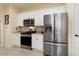 Modern kitchen featuring stainless steel appliances, white cabinets, and a practical layout at 22524 N San Ramon Dr, Sun City West, AZ 85375