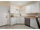 Well-lit kitchen features a corner sink, white cabinets, and stainless steel dishwasher at 22524 N San Ramon Dr, Sun City West, AZ 85375