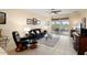 Spacious living room featuring tile floors and a sliding glass door that opens to a serene patio at 22524 N San Ramon Dr, Sun City West, AZ 85375