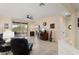 Bright living room featuring tile flooring, a ceiling fan, and access to the outdoor patio at 22524 N San Ramon Dr, Sun City West, AZ 85375