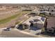 Aerial view of a single Gathering home with solar panels in a Primary-planned community with green space and walking paths at 24847 N 175Th Dr, Surprise, AZ 85387