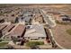 Aerial view of a Primary-planned community showing roof tops and a home with a cozy outdoor patio and landscaping at 24847 N 175Th Dr, Surprise, AZ 85387