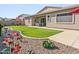 Backyard featuring an extended covered patio with a dining table and chairs, artificial turf, and desert landscaping at 24847 N 175Th Dr, Surprise, AZ 85387