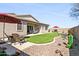 Backyard featuring an extended covered patio with a dining table and chairs, artificial turf, and desert landscaping at 24847 N 175Th Dr, Surprise, AZ 85387