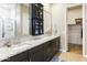 Bathroom featuring double sinks, granite countertops, a large mirror, and a shower with glass door at 24847 N 175Th Dr, Surprise, AZ 85387