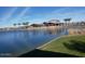 View of the clubhouse and outdoor seating alongside the pond in the Primary-planned community at 24847 N 175Th Dr, Surprise, AZ 85387