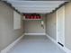 Garage featuring epoxy floors, overhead storage, window and access door at 24847 N 175Th Dr, Surprise, AZ 85387