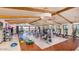 Spacious gym with wooden beam ceiling, modern equipment and floor to ceiling windows at 24847 N 175Th Dr, Surprise, AZ 85387