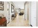 Inviting hallway with tile flooring leads to a cozy living area with natural light and neutral decor at 24847 N 175Th Dr, Surprise, AZ 85387