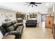 Spacious open-concept living area with modern tile flooring connecting the kitchen and living spaces at 24847 N 175Th Dr, Surprise, AZ 85387