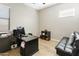 Home office with desk, shelving, and a comfortable futon for relaxation at 24847 N 175Th Dr, Surprise, AZ 85387