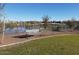 Serene park view with bench seating by the lake in a well-maintained community at 24847 N 175Th Dr, Surprise, AZ 85387