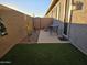 Enclosed patio with artificial turf, patio table, and desert landscaping offers privacy and a cozy outdoor space at 24847 N 175Th Dr, Surprise, AZ 85387