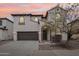 Charming stucco two-story home boasts a two-car garage and arched entry with stone accents at 2502 S 90Th Gln, Tolleson, AZ 85353