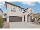 Two-story home featuring stucco exterior, arched entryway, and a two-car garage at 2502 S 90Th Gln, Tolleson, AZ 85353