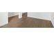 Close-up view of the wood-look flooring and clean white baseboards at 2502 S 90Th Gln, Tolleson, AZ 85353