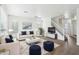 Bright living room features a white couch, plush rug, staircase, and ample natural light at 2502 S 90Th Gln, Tolleson, AZ 85353