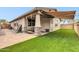 Inviting covered patio with lounge chairs and low-maintenance artificial grass for outdoor enjoyment at 256 N Jesse St, Chandler, AZ 85225