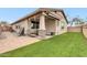 Home exterior features a covered patio with a stone column and a grassy backyard at 256 N Jesse St, Chandler, AZ 85225